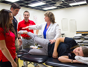 Professor showing how to stretch leg